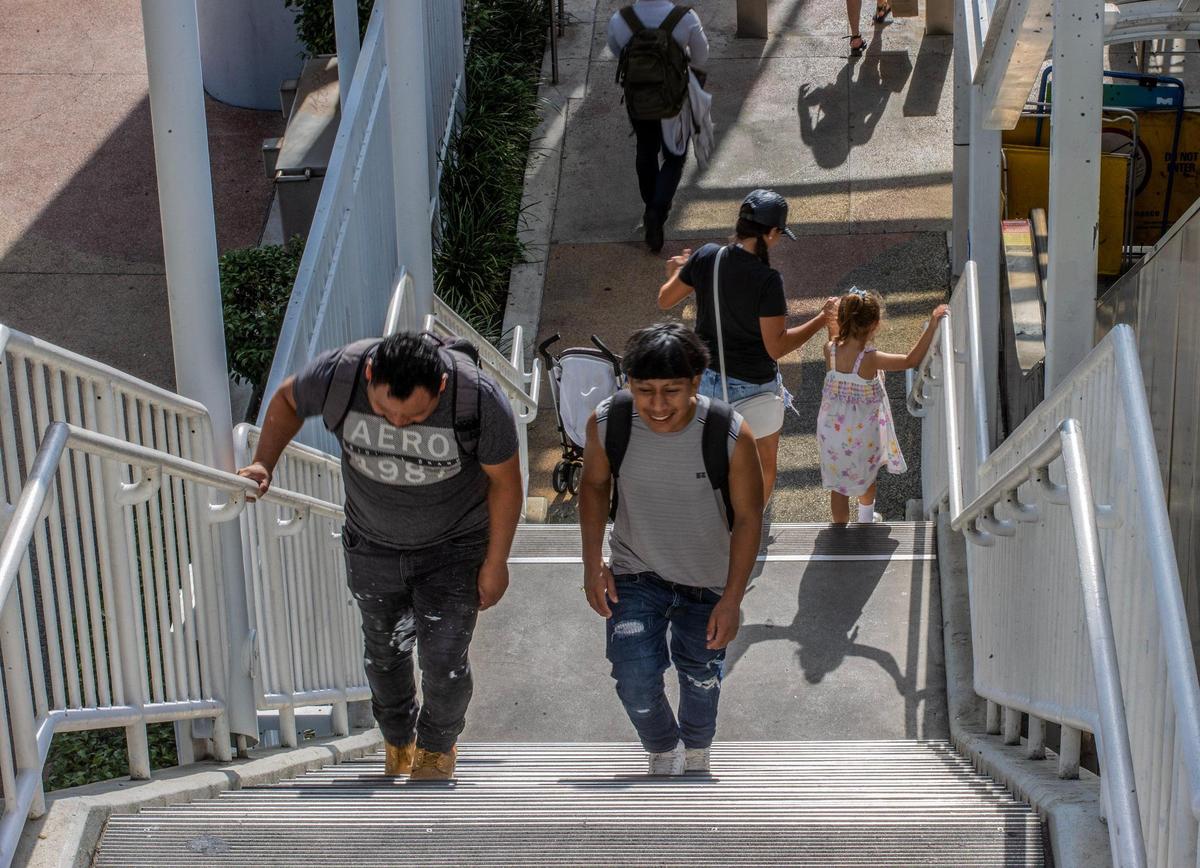 Metromover users are forced to walk down the stairs on Tuesday, May 16, 2023, at the Adrienne Arsht Center Station in Miami with the elevator and escalator broken.