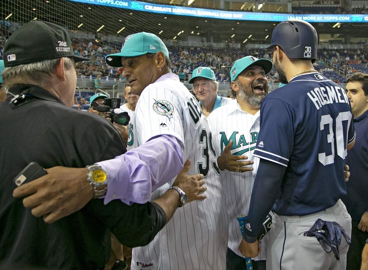 Former Marlins Orestes Destrade, at left, greets staff on the field as Alex Fernandez meets up with the Padres Eric Hosmer (30) as the Miami Marlins prepare to host the San Diego Padres at Marlins Park on Saturday, June 9, 2018. 