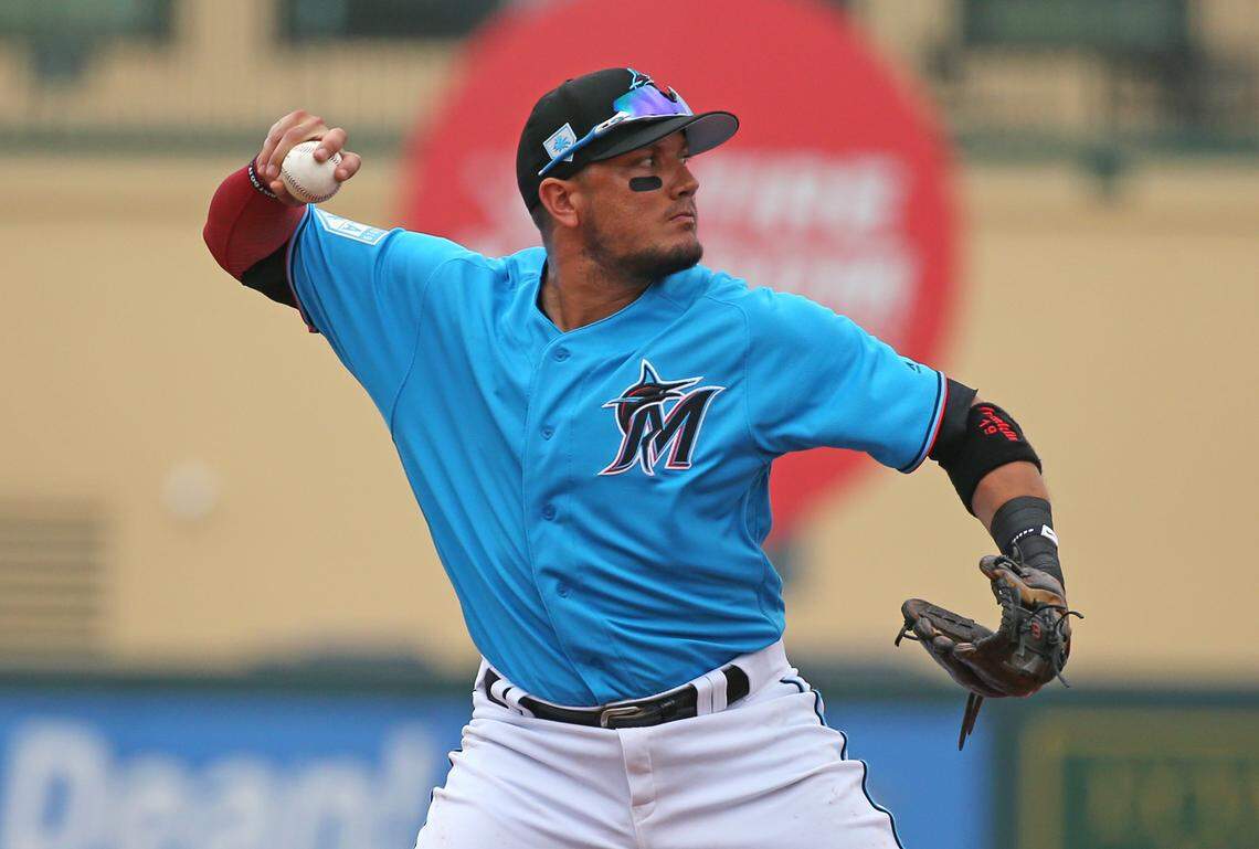 Miami Marlins shortstop Miguel Rojas (19) throws to first base to put out Houston Astros right fielder Jake Marisnick during the second inning of a Major League Baseball spring training game at Roger Dean Chevrolet Stadium on Tuesday, February 26, 2019 in Jupiter, FL .
