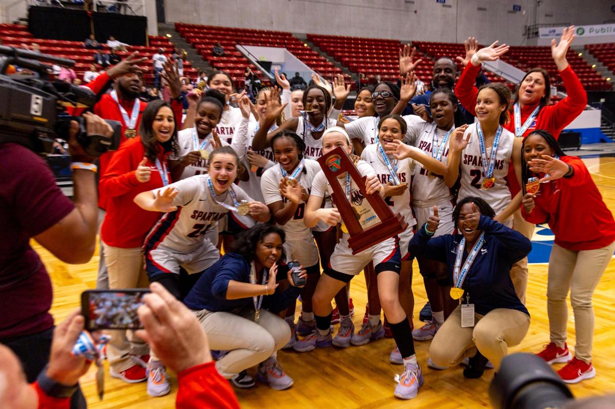 Miami Country Day players react with the first place trophy after defeating Cardinal Mooney 54-38 during the Class 3A state Girl’s basketball championship game at RP Funding Center in Lakeland, Florida, on Saturday, February 25, 2023.