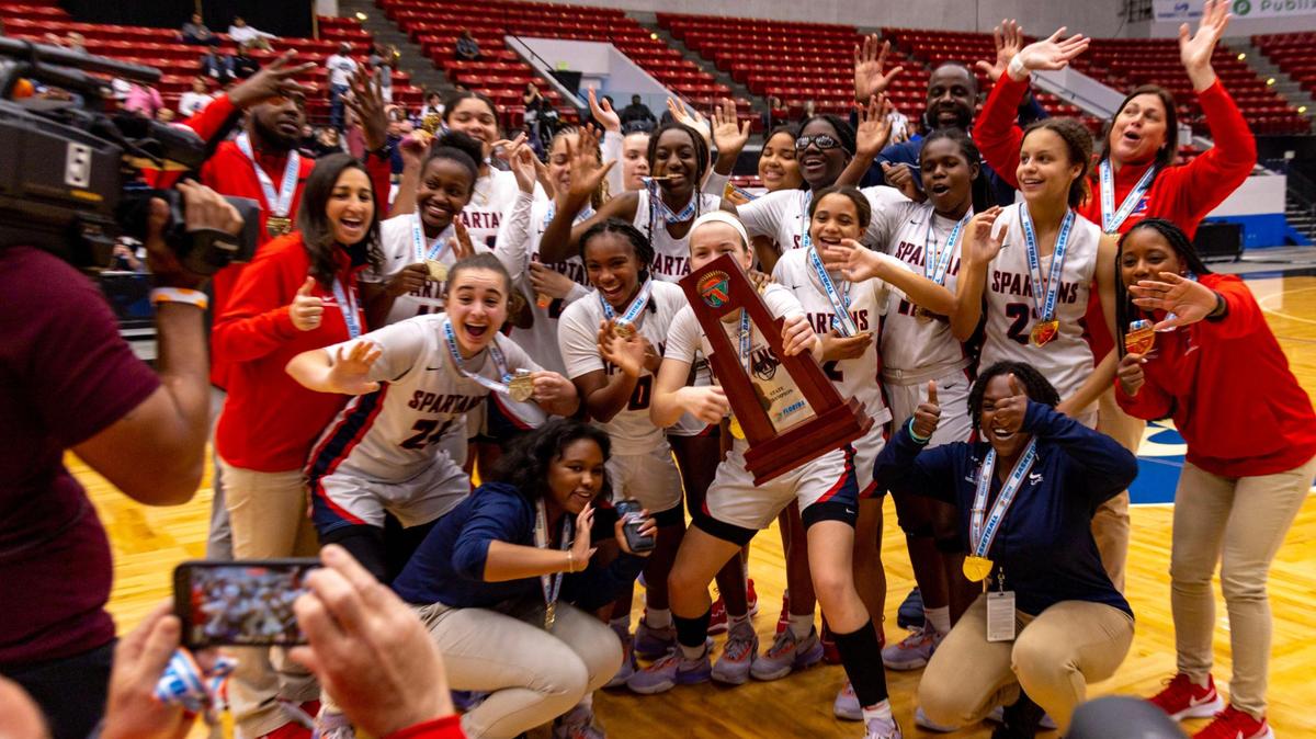 Miami Country Day players react with the first place trophy after defeating Cardinal Mooney 54-38 during the Class 3A state Girls’ basketball championship game at RP Funding Center in Lakeland, Florida, on Saturday, February 25, 2023.