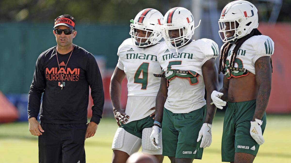 Miami Hurricanes head coach Manny Diaz with safety Keontra Smith (4), safety Amari Carter (5) and defensive back Robert Knowles (20) during practice drills at the University of Miami Greentree Practice Field in Coral Gables on on Wednesday, September 25, 2019.