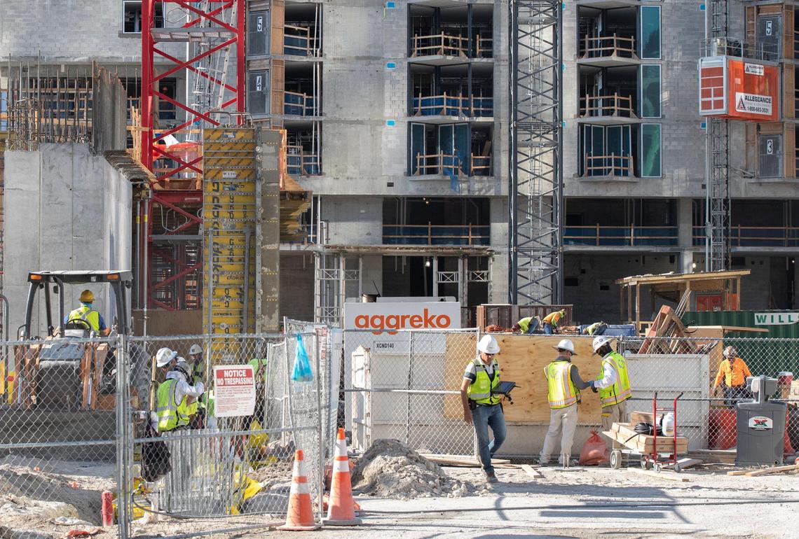 Workers at the Miami Worldcenter site on NE Second Avenue and NE Eighth Street in downtown Miami on Thursday, April 2, 2020.