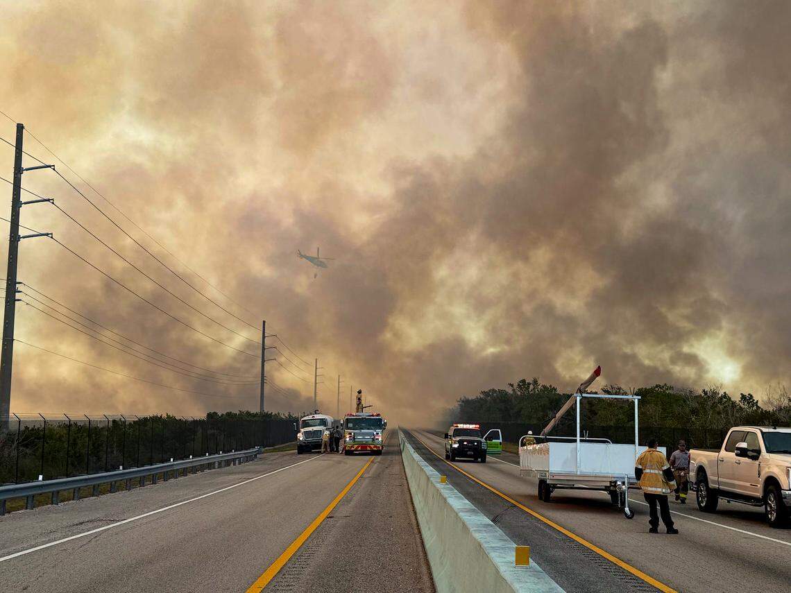 A brush fire on Card Sound Road in south Miami-Dade near Florida City on Tuesday, March 18, 2025, has closed Card Sound Road and led to intermittent closures of U.S. 1 heading into the Florida Keys.