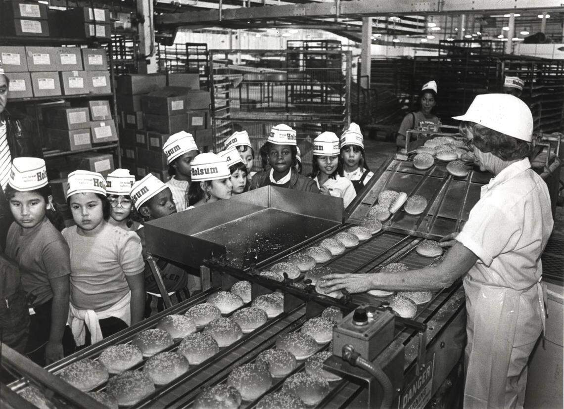 Students of Tucker Elementary take a tour of the Holsum Bakery plant. At the right is operator