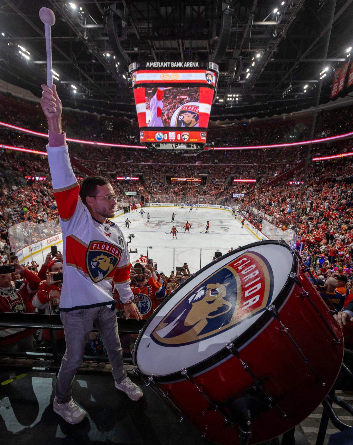 Sunrise, Florida, June 8, 2024 - Miami Dolphins Head Coach Mike McDaniel bangs the drum leading cheers for the home team during game 1 of the Stanley Cup Final at Amerant Arena in Sunrise, Florida.