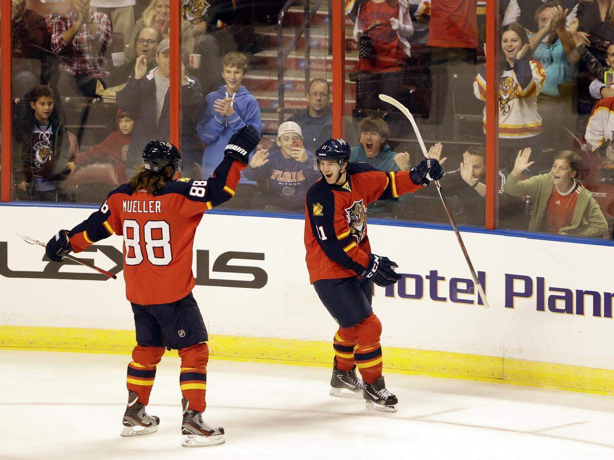 Florida Panthers center Jonathan Huberdeau of Canada, right, celebrates his first goal with right wing Peter Mueller (88) during the first period of an NHL hockey game against the Carolina Hurricanes, Saturday, Jan. 19, 2013 in Sunrise, Fla.