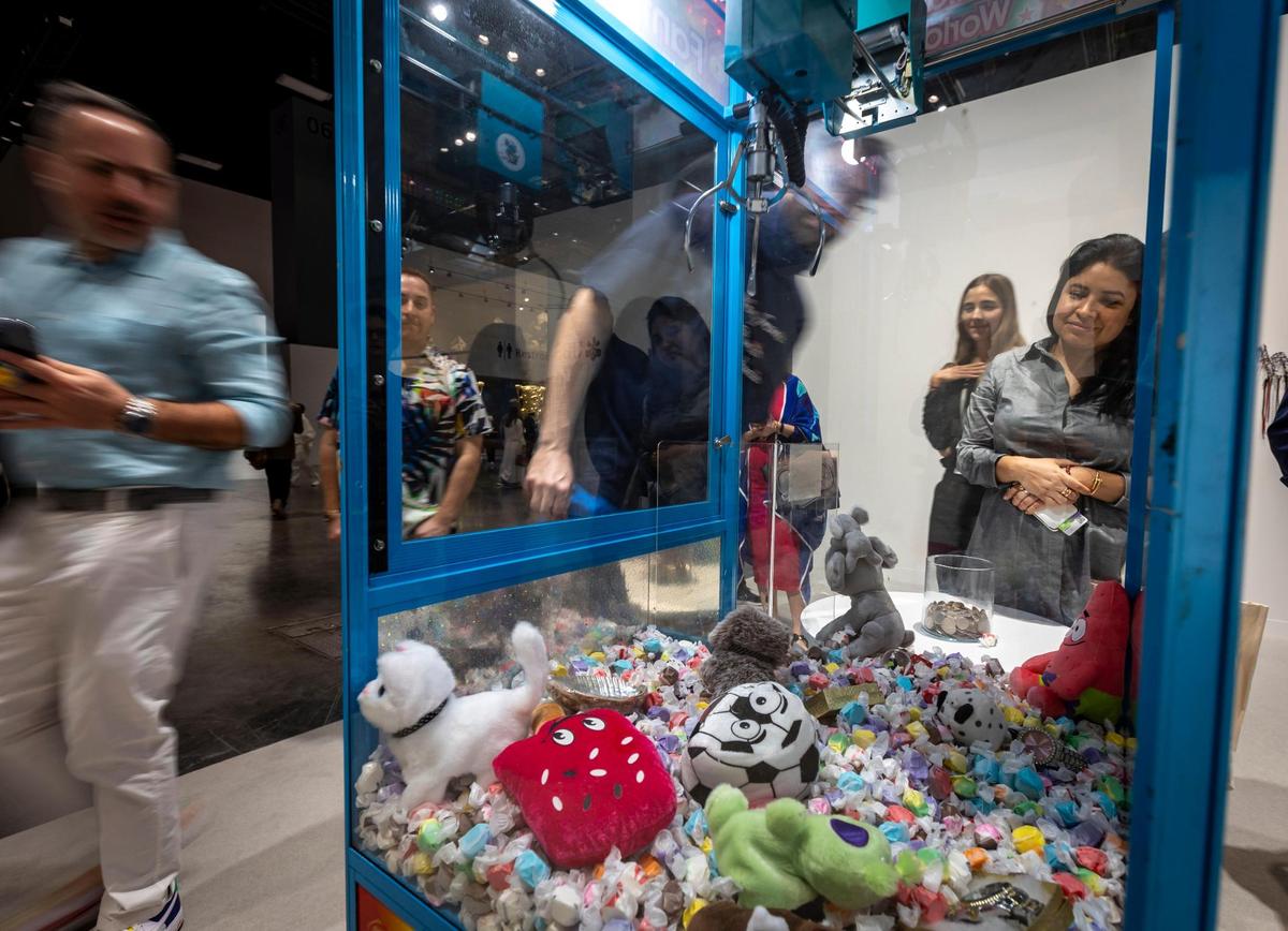 Miami Beach, Florida, December 6, 2023 - A Claw Machine that guests were invited to play with called Fantasy World by artist Anthony Akinbola at Meridians during Art Basel VIP day at the Miami Beach Convention Center.