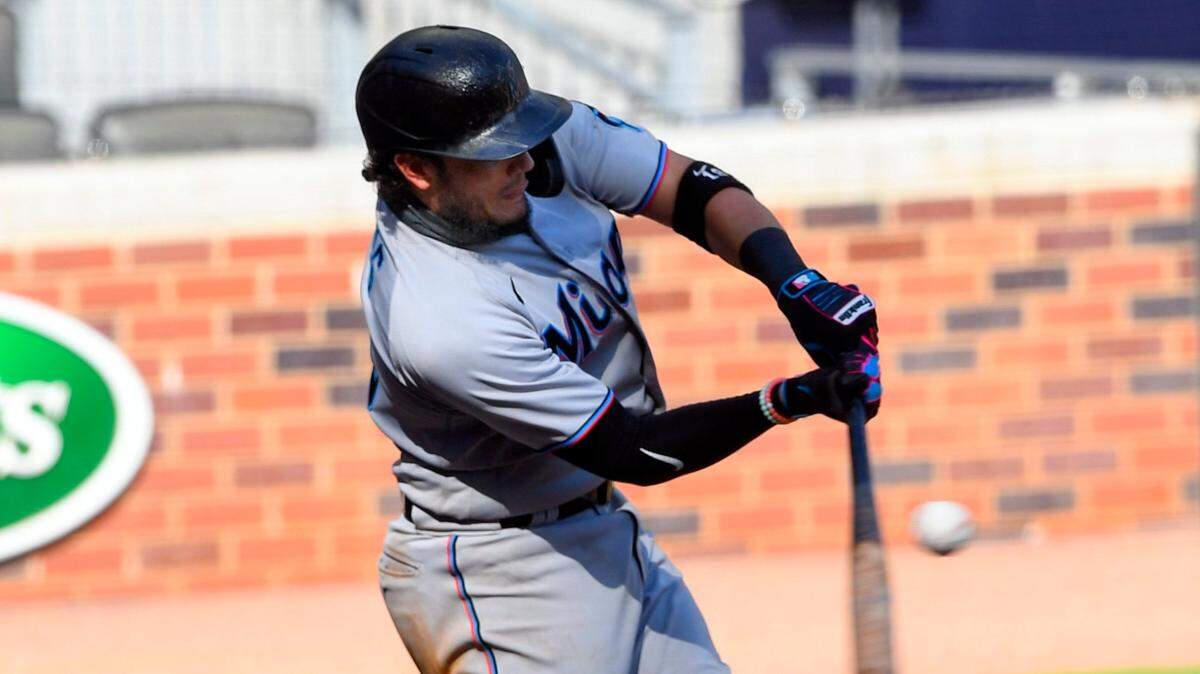 Miami Marlins’ Migual Rojas connects for a go-ahead one-run double to center field during the 10th inning of a baseball game against the Atlanta Braves, Monday, Sept. 7, 2020, in Atlanta.
