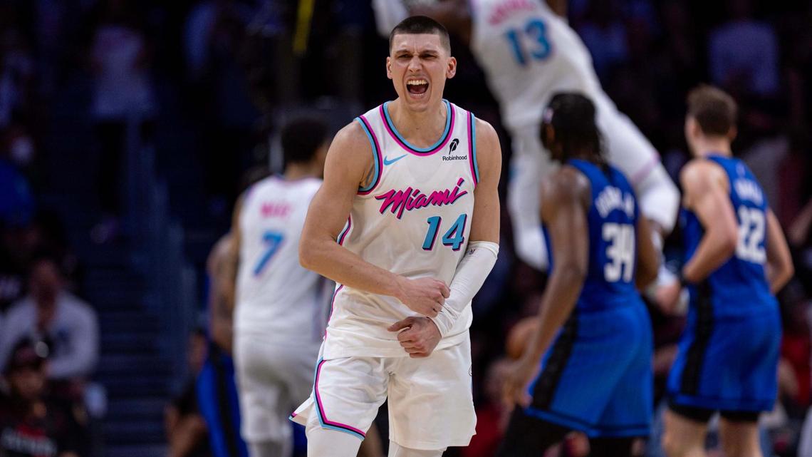 Miami Heat guard Tyler Herro (14) reacts to his teammate Bam Adebayo (13) dunking during double overtime of an NBA game at Kaseya Center on January 27, 2025, in Miami.