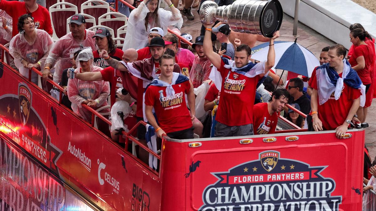 Florida Panthers center Aleksander Barkov lifts the Stanley Cup alongside teammates as fans cheers during the Florida Panthers victory parade before the Stanley Cup victory parade at Fort Lauderdale Beach on Tuesday, June 30, 2024 in Fort Lauderdale. 