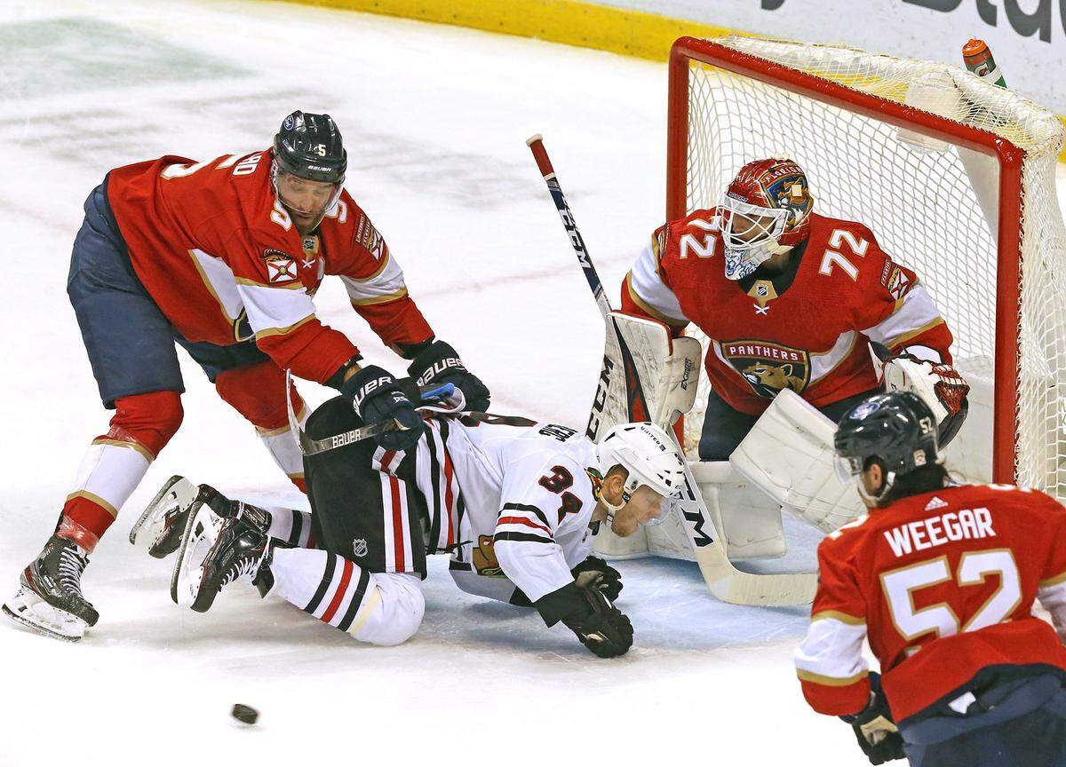 Florida Panthers Aaron Ekblad (5) and goalie Sergei Bobrovsky (72) and Chicago Blackhawks Brandon Hagel (38) in the first period at the BB&T Center in Sunrise, Florida, Monday, March 15, 2021.