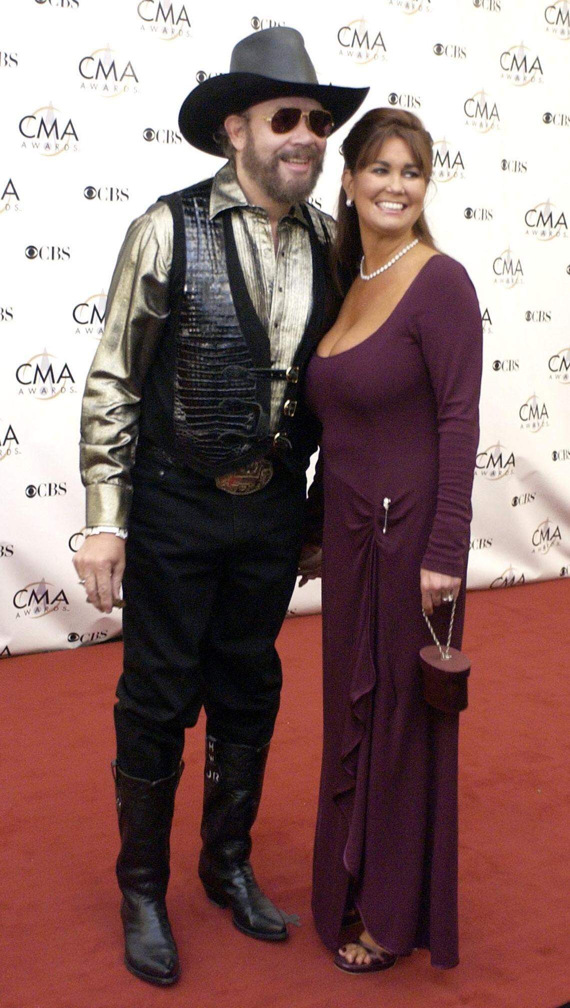 Hank Williams Jr. and his wife, Mary Jane, arrive for the 37th annual Country Music Association Awards show in Nashville, Tenn. in a Wednesday, Nov. 5, 2003 photo. Hank Williams Jr. has filed for divorce from his wife of 16 years, Mary Jane, saying she has a problem with addiction, he said in a statement Friday.