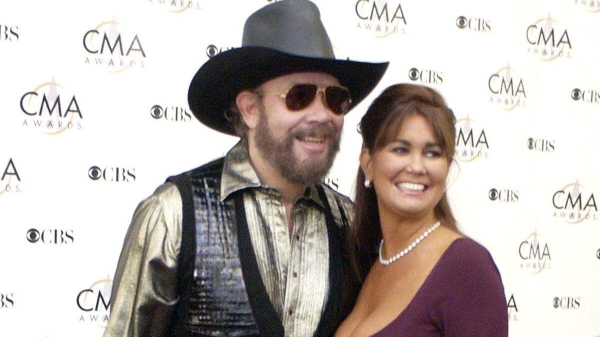 Hank Williams Jr. and his wife, Mary Jane Thomas, arrive for the 37th annual Country Music Association Awards show in Nashville, Tennesee in a Nov. 5, 2003 file photo. Thomas died in Jupiter, Florida, on March 22, 2022 at 58.