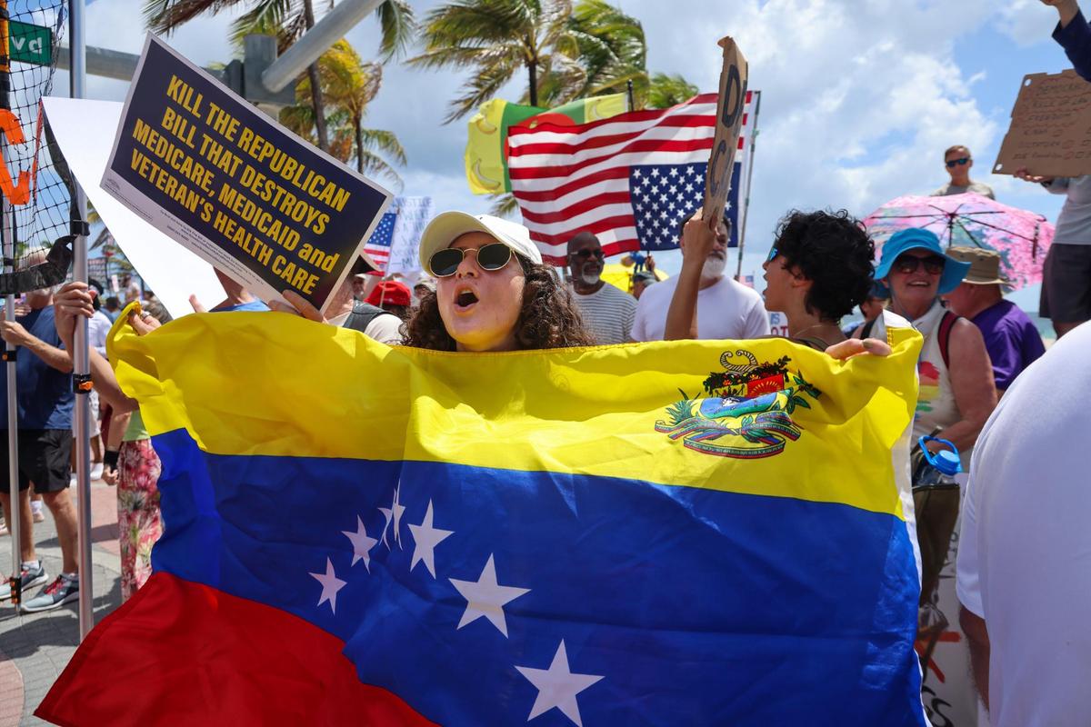 Maria waves the Venezuela flag as she protest in behalf of her country-persons being returned as protesters line A1A chants of discontent during the national “No Kings Days” in Fort Lauderdale. At its peak between 400-500 peaceful protestors gathered at Fort Lauderdale’s No Kings Protest on the A1A and Sunrise Boulevard Saturday. The rally was just one of hundreds being held across the country on the birthday of President Trump, Saturday, June 14, 2025.