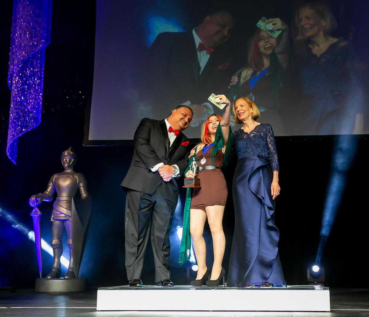 Silver Knight winner in Art Anabelle Figueroa, from Coral Reef Senior High, takes a selfie with Alex Mena, managing editor of the Miami Herald and el Nuevo Herald, and Joan Chrissos, education and health editor of the Miami Herald, after receiving her award during the Miami Herald & el Nuevo Herald 64th Annual Silver Knight Awards at the James L. Knight Center in Miami on Thursday, May 26, 2022.