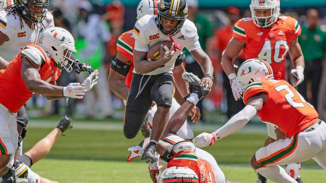 Southern Miss Golden Eagles running back Frank Gore Jr. (3) leaps as he tries to break A tackle by Miami Hurricanes cornerback Tyrique Stevenson (2) and the Canes defense in the fourth quarter at Hard Rock Stadium in Miami Gardens on Saturday, September 10, 2022.