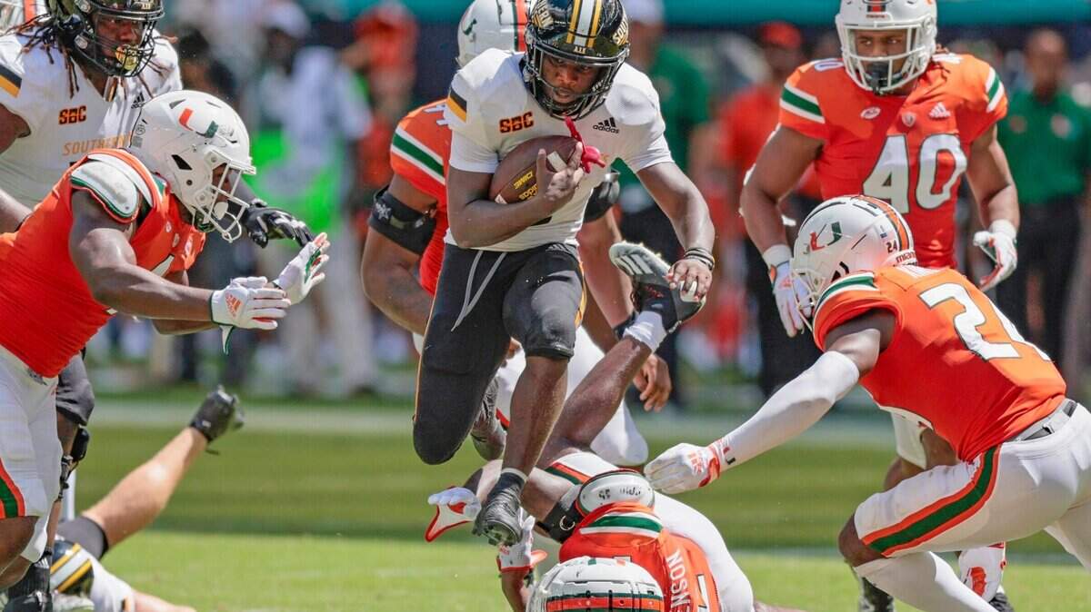 Southern Miss Golden Eagles running back Frank Gore Jr. (3) leaps as he tries to break A tackle by Miami Hurricanes cornerback Tyrique Stevenson (2) and the Canes defense in the fourth quarter at Hard Rock Stadium in Miami Gardens on Saturday, September 10, 2022.
