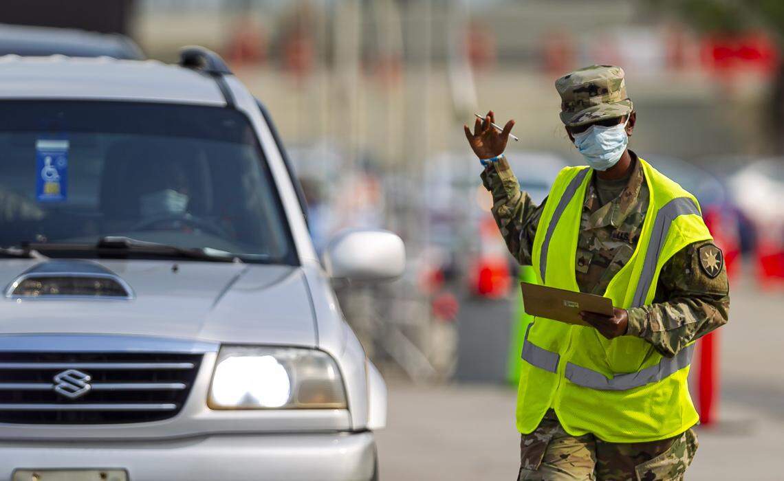 A COVID-19 drive-thru testing center operates in a parking lot near the Hard Rock Stadium in Miami Gardens, one sign of a county transformed by COVID-19 and the economic restrictions to slow its spread. Miami-Dade’s first budget forecasts predict a nearly $300 million loss in long-term revenue from the fallout.