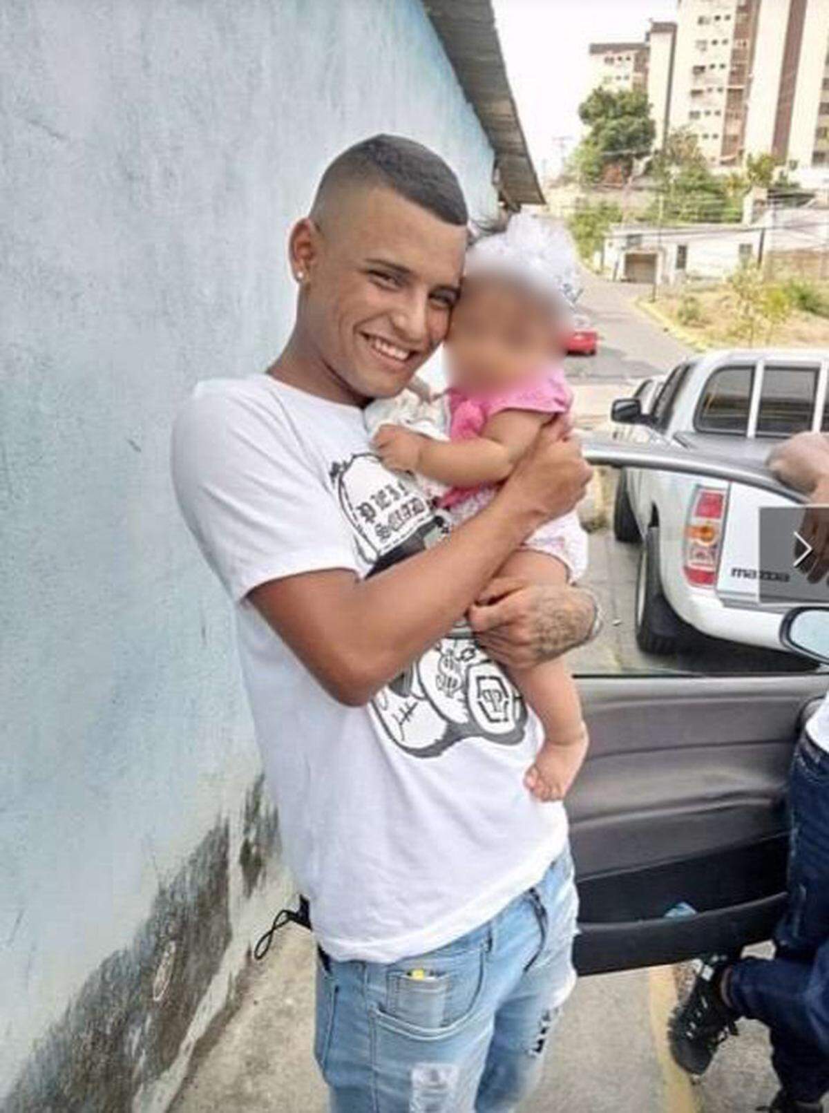 Yoiner Jose Purroy Roldan, who was detained in Guantanamo, holds his daughter in an undated photo provided by his family. 