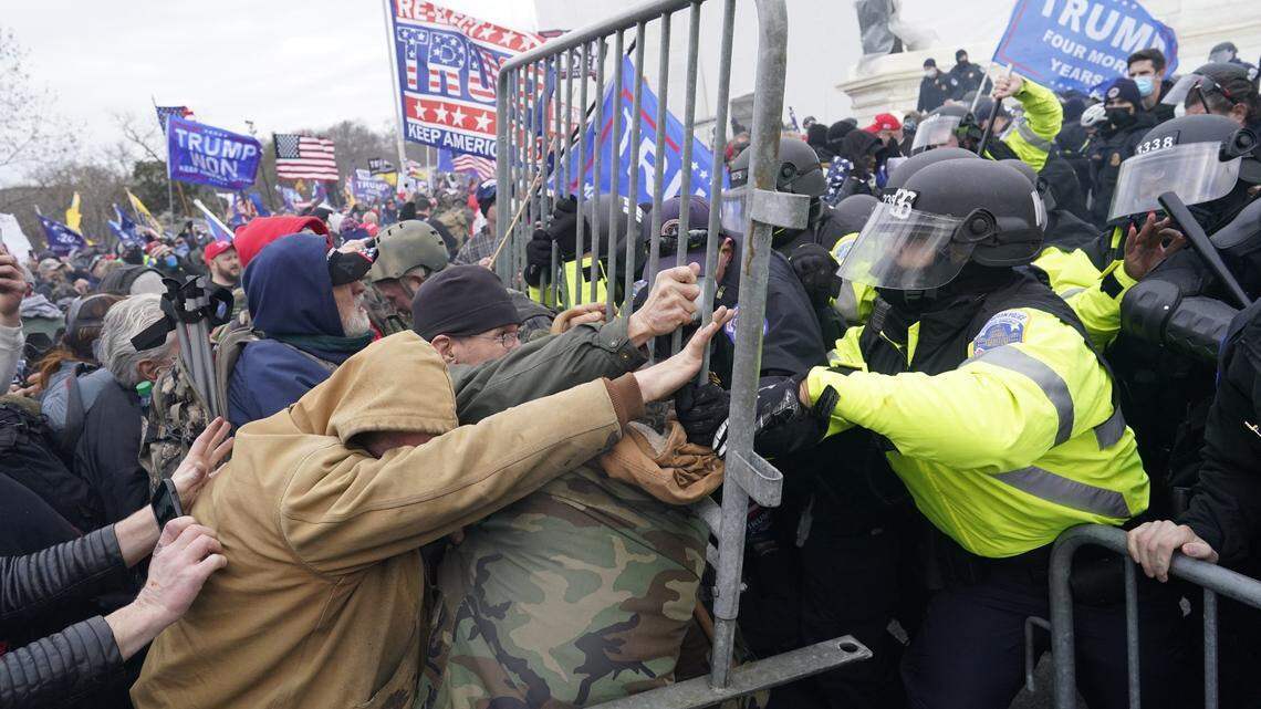 Pro-Trump supporters attack police as they storm the U.S. Capitol on Wednesday, Jan. 6, 2021, in an effort to overturn the presidential election results. A joint session of Congress was meeting that day to count and certify the Electoral College votes showing that President-elect Joe Biden defeated Donald Trump in the Nov. 3 election, by a margin of 306 to 232.