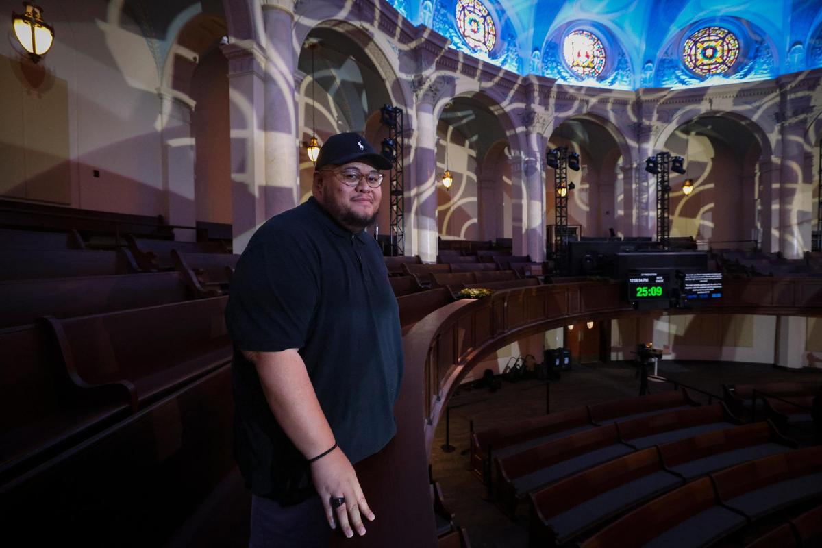 Pastor Gideon Apé, Christ Fellowship’s Downtown Launch Campus Pastor, poses in the balcony during preparations for the historic church’s re-opening after about $20 million in renovations.