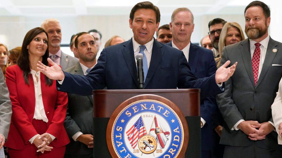 Surrounded by lawmakers, Florida Gov. Ron DeSantis speaks at the end of a legislative session, Friday, April 30, 2021, at the Capitol in Tallahassee, Fla.