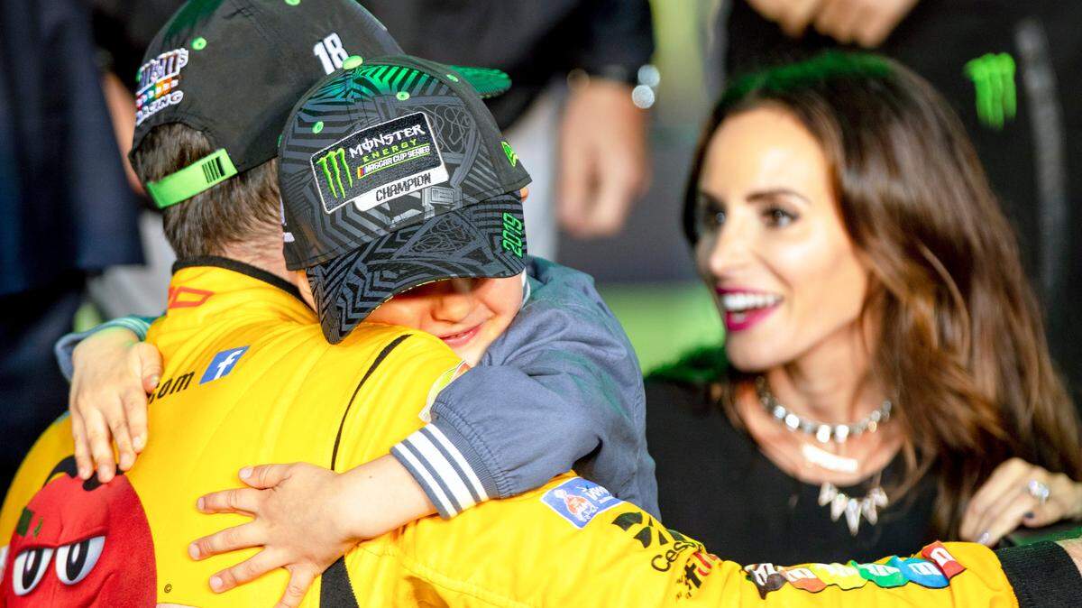 Kyle Busch (18) hugs his son Brexton Locke Busch next to his wife Samantha after winning the Homestead-Miami Speedway NASCAR 21st Annual Ford EcoBoost 400 Monster Energy Series in Homestead, Florida on Sunday, Nov. 17, 2019.