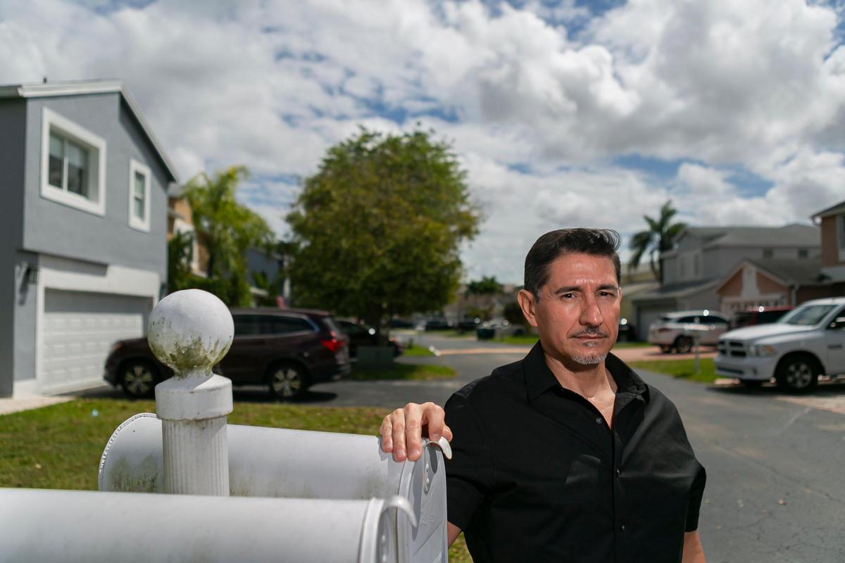 Daniel Ore, 54, a department chair in the Miami-Dade Schools social work program, visits the home of Arnold Ulloa and Wendy Bustamante.