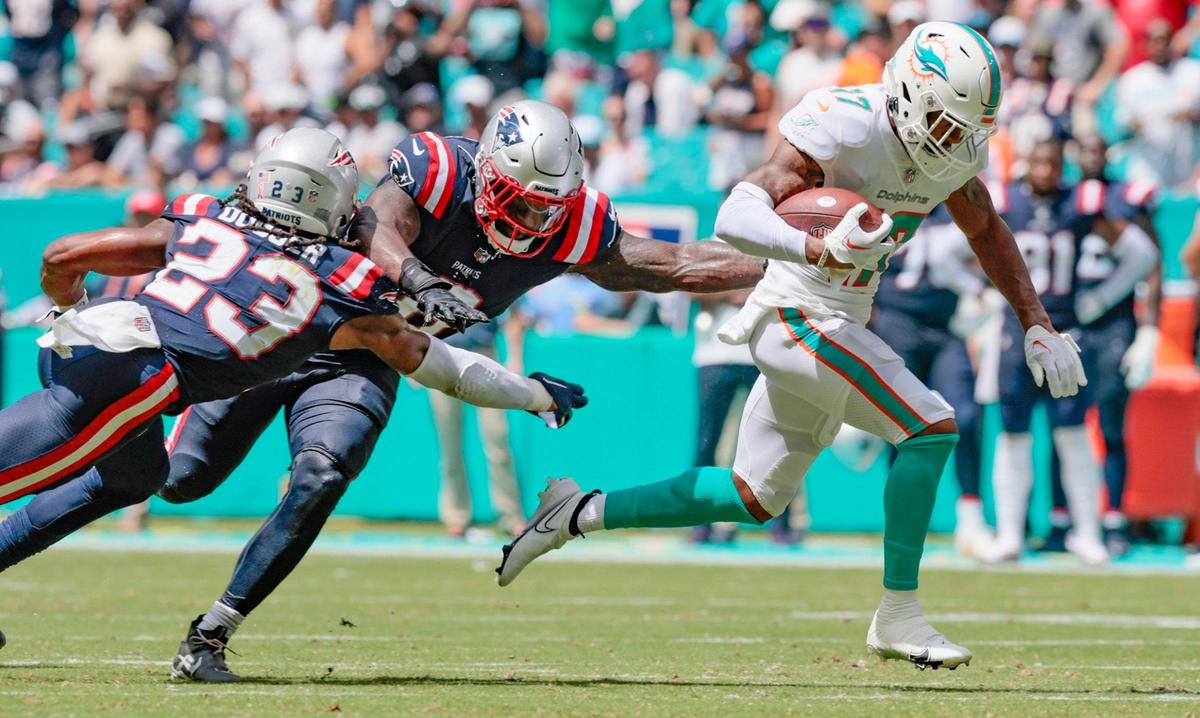 Miami Dolphins wide receiver Jaylen Waddle (17) runs past New England Patriots safety Kyle Dugger (23) and linebacker Ja’Whaun Bentley (8) to score in the second quarter at Hard Rock Stadium in Miami Gardens on Sunday, September 11, 2022.
