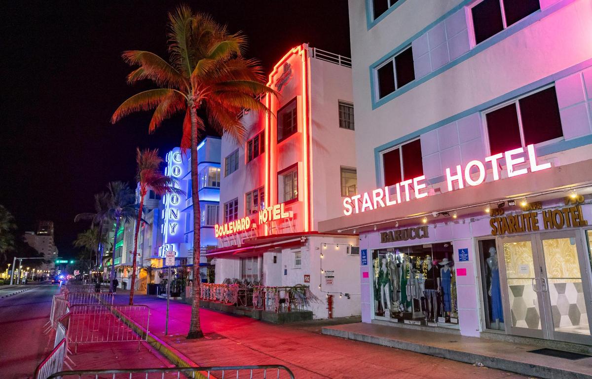 Police officers enforce a midnight curfew near Mango’s Tropical Cafe on Ocean Drive during spring break on Friday, March 15, 2024, in Miami Beach.