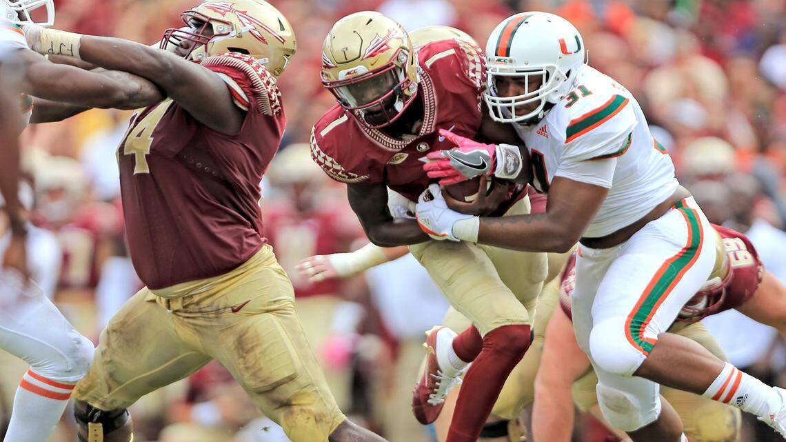 Miami Hurricanes running back Mark Walton (1) runs in the second quarter as the Seminoles host the Miami Hurricanes at Doak Campbell Stadium in Tallahassee on Saturday, Oct. 7, 2017.