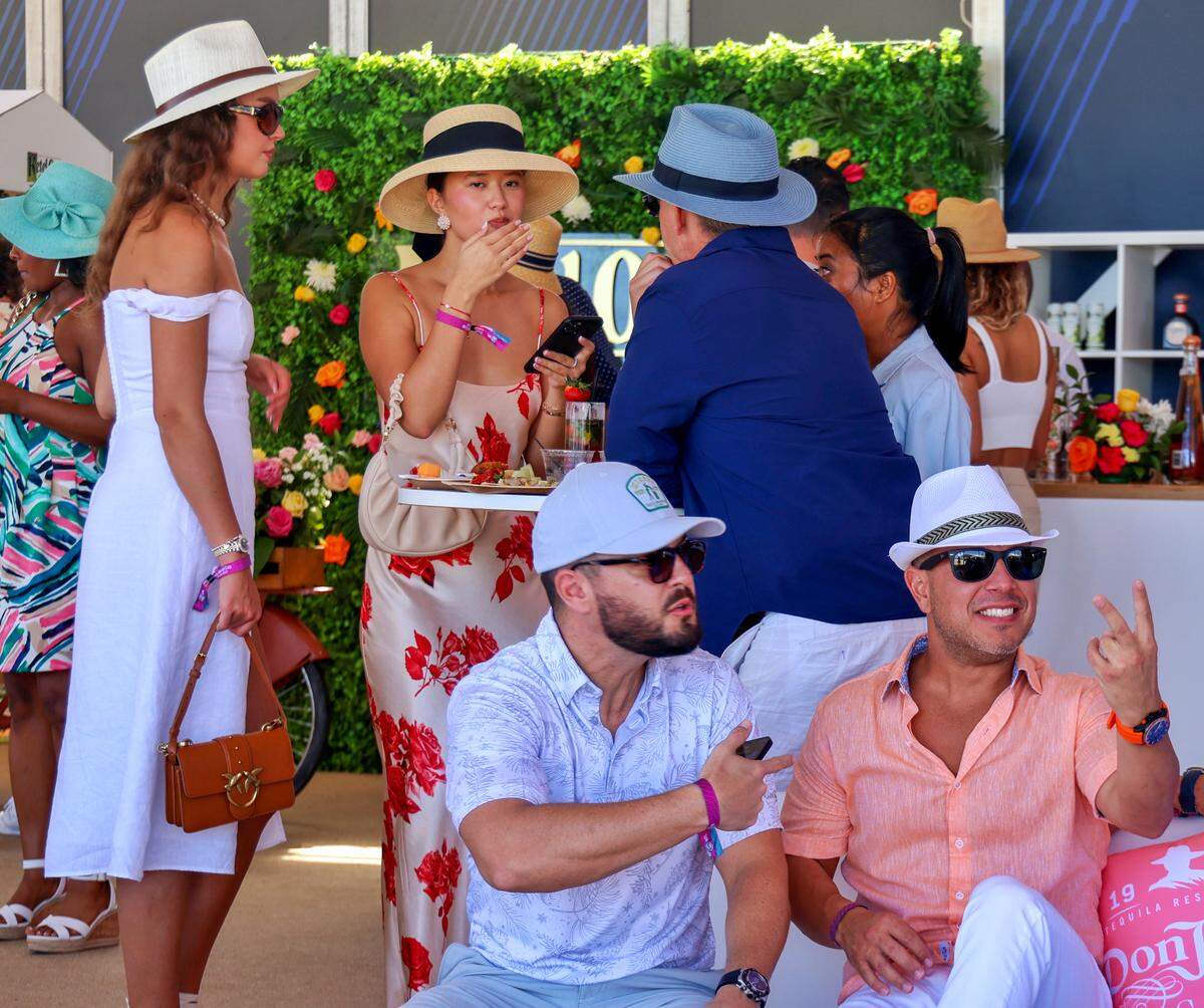 Hats are the fashion statement as spectators enjoy the food, drinks, and company between finals of the World Polo League season finale on Sunday, April 23, 2023 in Miami Beach, Florida.