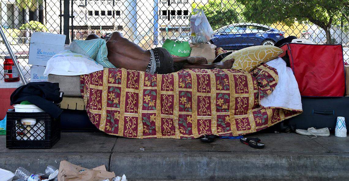 A homeless man sleeps under the I-95 overpass in downtown Miami.