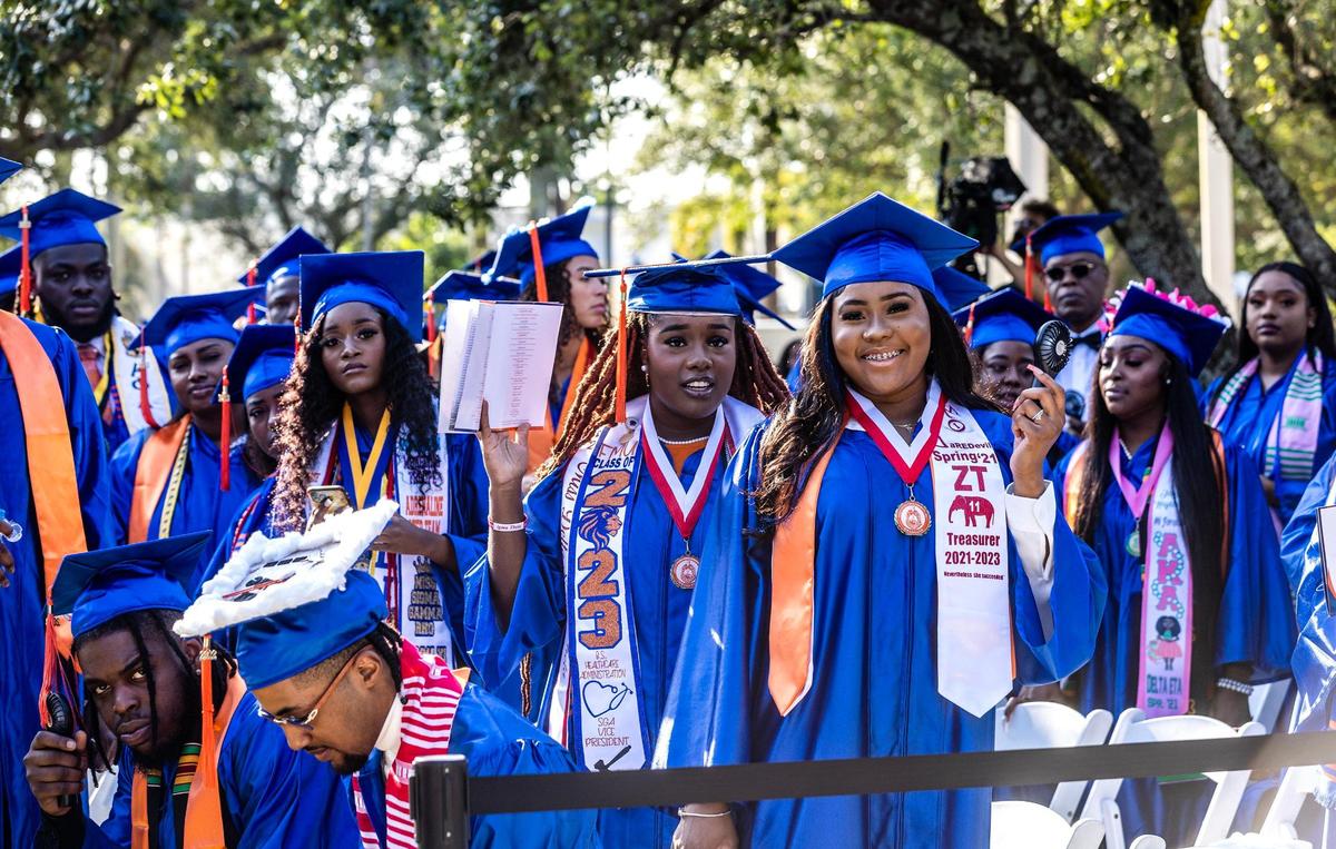 Jonell Fox (left), and Rudaria Higgs, both international students from Bahamas, smile during the spring commencement ceremony at Florida Memorial University in Miami Gardens, on Saturday May 6, 2023. Fox, 23, and Higgs, 21, both majored in psychology and both decorated their caps. Fox’s read “I trust the next chapter because I know the author,” and Higg’s read “Finally done with the BS.” Higgs described the past four years as “life-changing.” “These have been the best four years of my life,” she said.