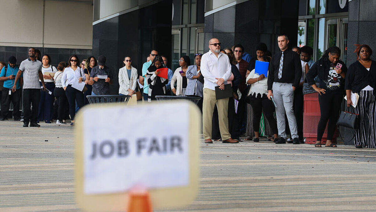 SUNRISE, FLORIDA - APRIL 30: People line up as they wait for the Mega JobNewsUSA South Florida Job Fair to open at the Amerant Bank Arena on April 30, 2025 in Sunrise, Florida.