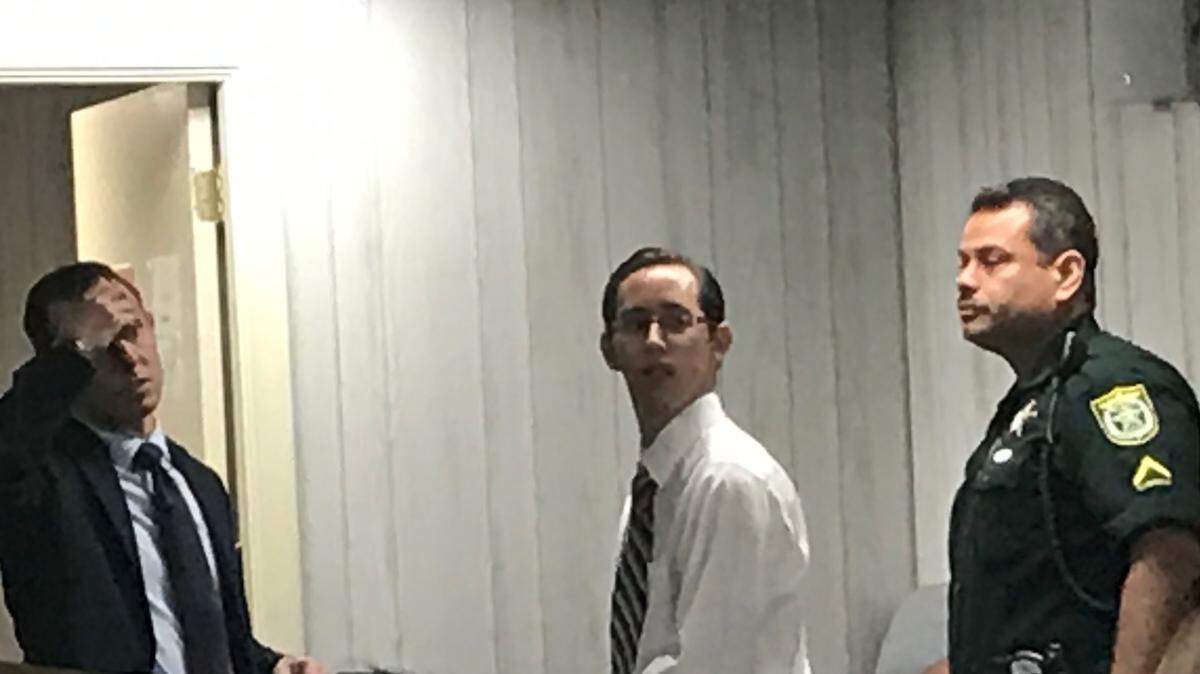 Defense attorney Jude Faccidomo, his client Argenis Alberto Acevedo-Feliciano and a Monroe County Sheriff’s Office Deputy stand in a Plantation Key courtroom Friday, Jan. 11, 2018, after a hearing in Acevedo-Feliciano’s rape case. The deputy was about to obtain a DNA swab from Acevedo-Feliciano.