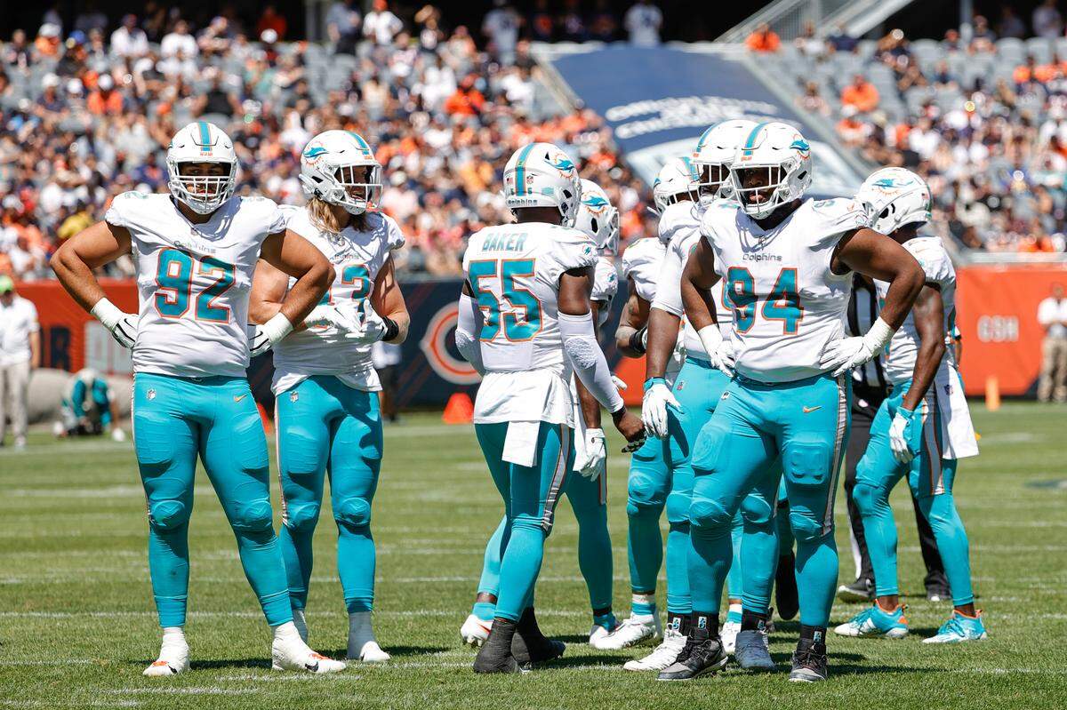 Miami Dolphins defensive end Zach Sieler (92) and defensive tackle Christian Wilkins (94) stand on the field with teammates during the first half of a preseason NFL football game against the Chicago Bears, Saturday, Aug. 14, 2021, in Chicago. (AP Photo/Kamil Krzaczynski)