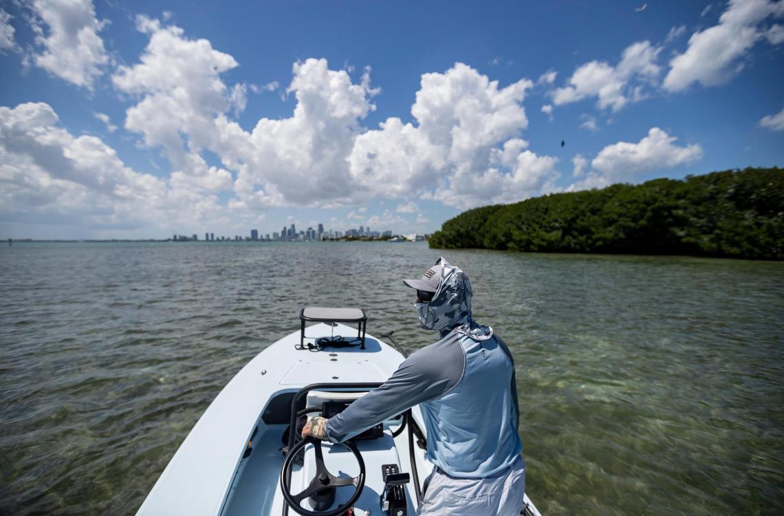 Fishing guide Carl Ball, 58, drives his boat near Crandon Park Marina on Saturday, April 22, 2023, in Key Biscayne, Fla.