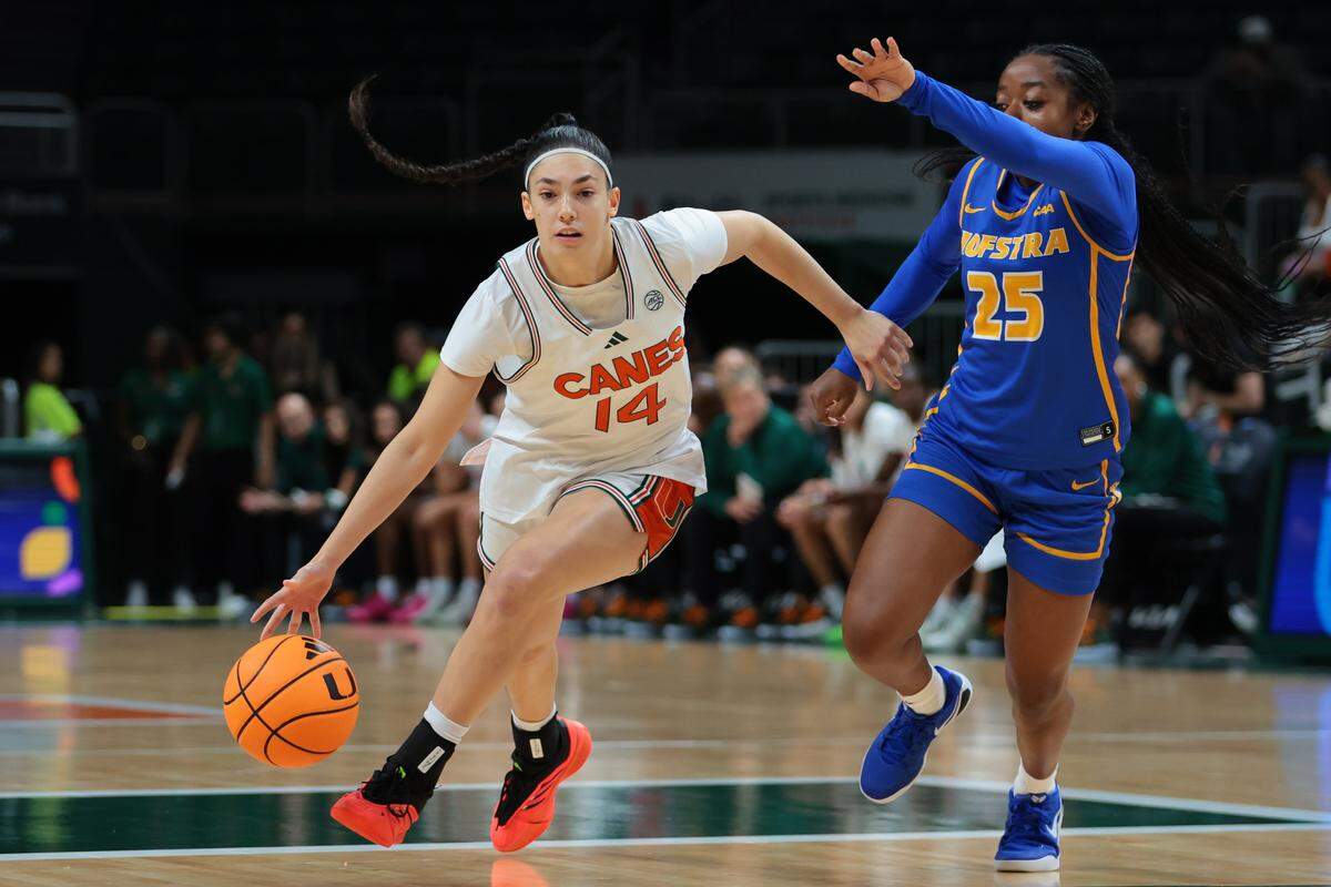 Miami Hurricanes guard Gal Raviv (14) drives to the basket against Hofstra Pride guard Micaela Carter (25) during the first quarter at Watsco Center, in Coral Gables, Florida, Monday, November 3, 2025. 