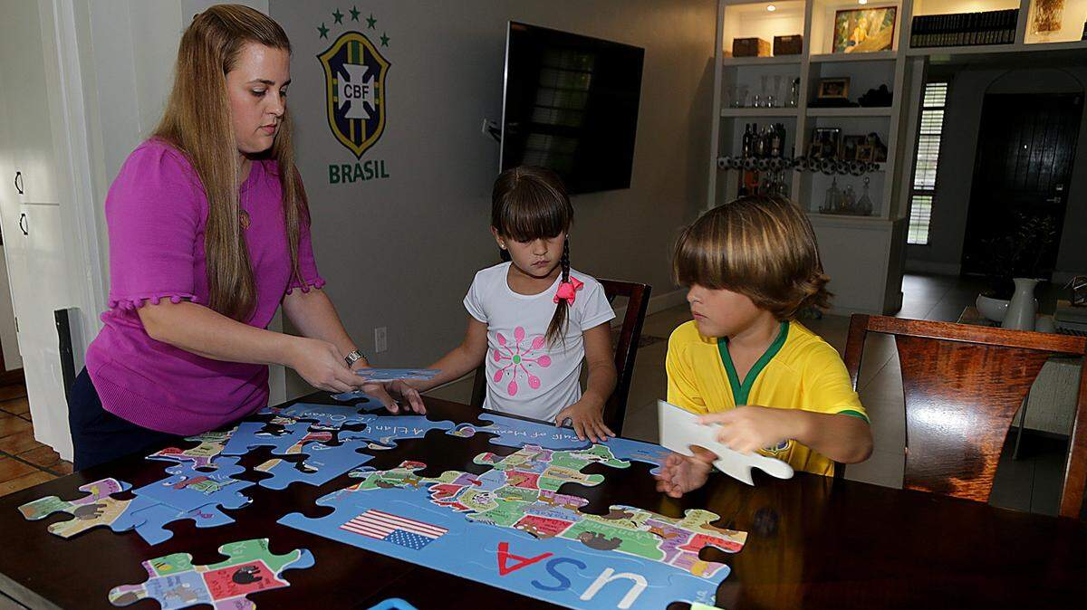 Sofia Miranda spends time with her kids Carolina, 6, and Lucas, 7, as they put together a puzzle. Sofia and her husband, Felipe, have strict screen time guidelines for their kids. They allow one hour of TV time a day during the week, no phone access, and computer time only for homework. They promote playing outside, sports and reading to foster healthy habits in their kids.