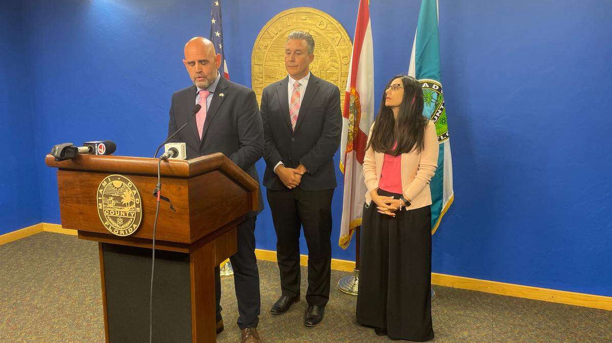 Maor Elbaz-Starinsky answers questions on Tuesday, Oct. 17, 2023, after Miami-Dade County commissioners unanimously passed a resolution condemning Hamas and endorsing Israel’s right to self-defense. Standing behind him are the two commissioners who sponsored the resolution: René Garcia and Micky Steinberg.