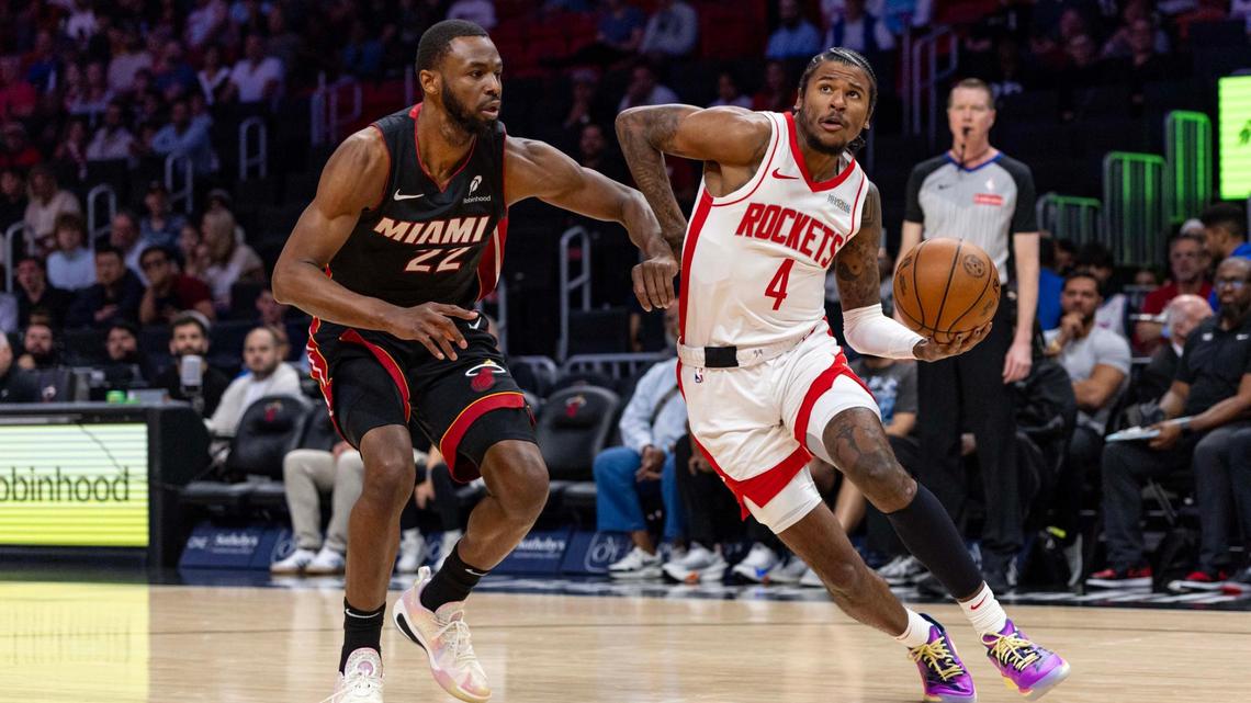 Houston Rockets guard Jalen Green (4) drives toward the basket while defended by Miami Heat forward Andrew Wiggins (22) during the first half of an NBA game at Kaseya Center on March 21, 2025, in Miami.