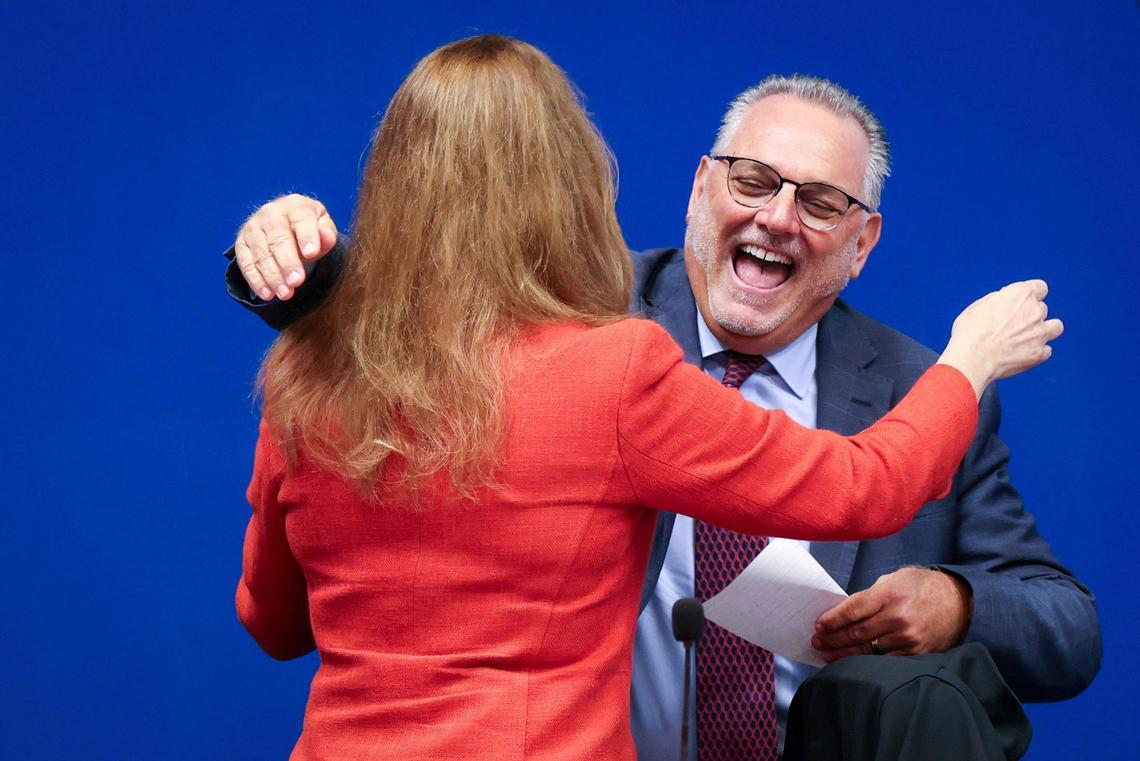 Marilyn Batista, general counsel, left, embraces Superintendent Peter Licata, as he prepares to take his seat among Broward School Board members after his contract was approved. Broward School Board’s held a special meeting to vote on the new superintendent’s contract inside the Board Room at the Kathleen C. Wright Building in Fort Lauderdale, Florida on Tuesday, July 11, 2023.