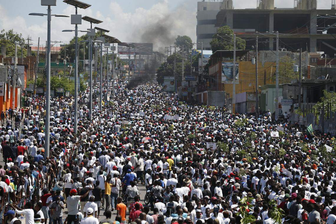 Protesters led by the art community demand the resignation of Haitian President Jovenel Moise as they march through Port-au-Prince, Haiti, Sunday, Oct. 13, 2019. Protests have paralyzed the country for nearly a month, shuttering businesses and schools.