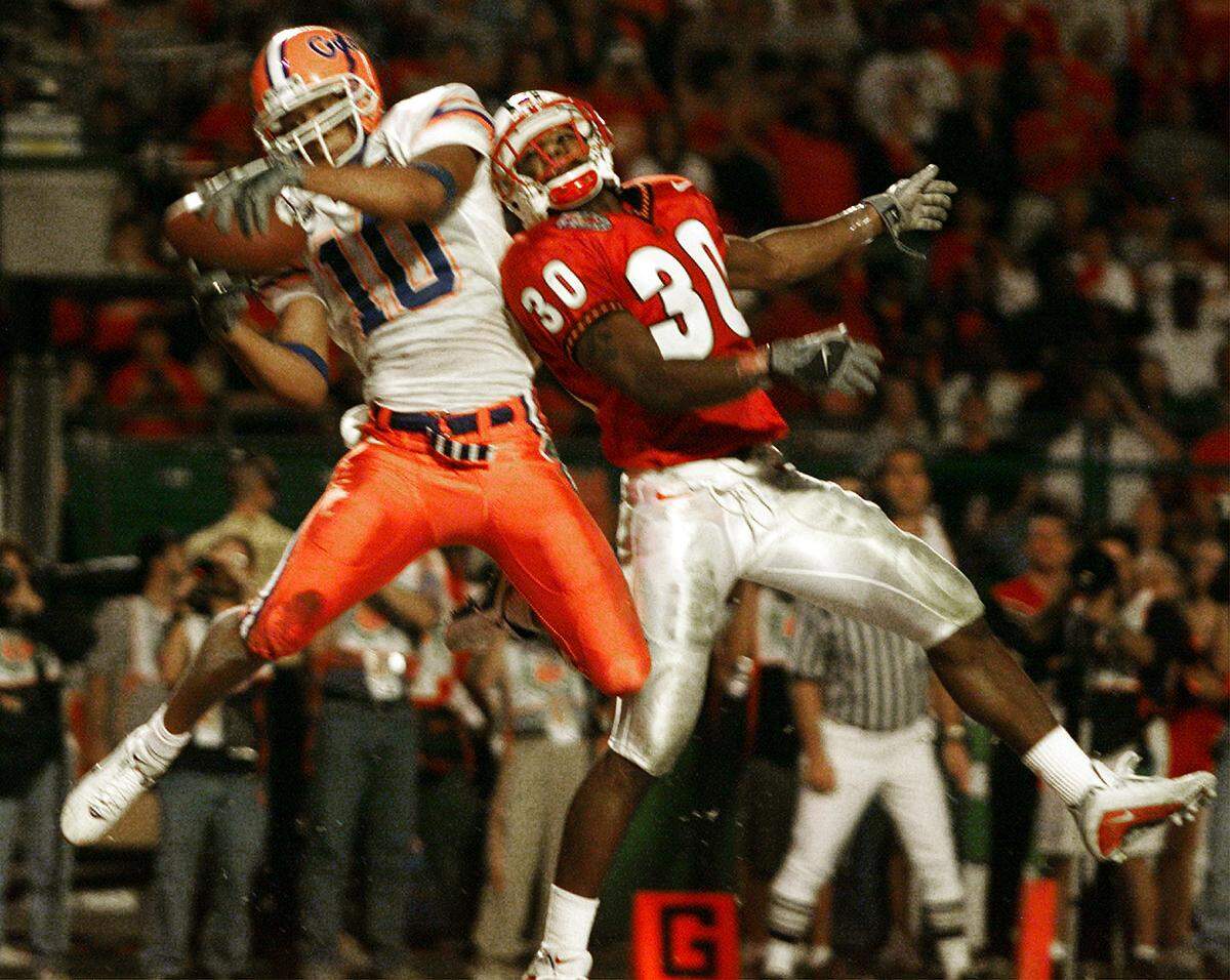 1/3/02 - Photo by Jared Lazarus/Herald staff - UF’s Jabar Gaffney (WR) leaps for a TD catch over Maryland’s Curome Cox (CB) late in the second quarter to give the Gators a 28-10 lead in the Orange Bowl at Pro Player Stadium on Wednesday night.