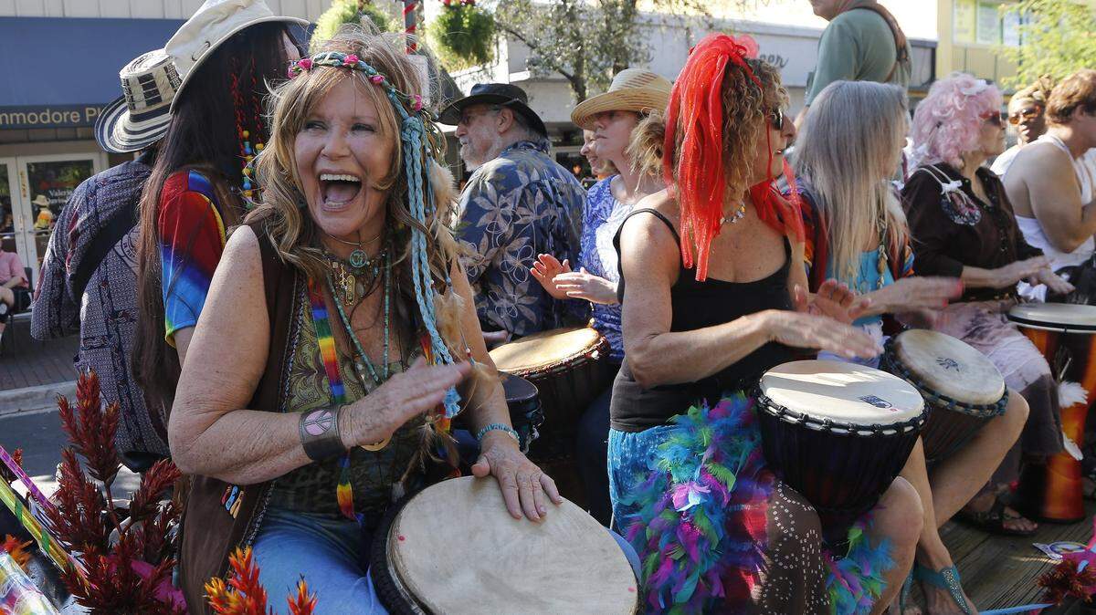 Grovite Karen Tilke, left, beats the drums with members of the Coconut Grove Drum Circle. The 33rd annual King Mango Strut marched down the streets of Coconut Grove on Sunday, Dec. 28, 2014, at 2 p.m., where South Florida’s wackiest citizens come out to entertain the masses with the biggest newsmakers of the year.