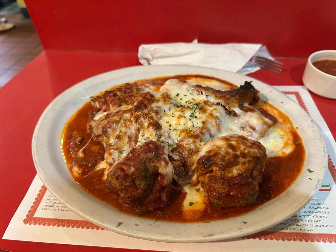 A just-served steaming plate of The Art Kehoe Atkin Special menu item at The Big Cheese — grilled chicken, meatballs, sausage, meat sauce with cheese melted over the top — that is named for the five-time Hurricanes national championship offensive line coach.