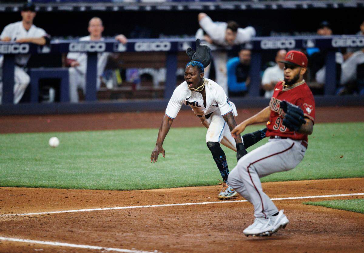 Miami Marlins second baseman Jazz Chisholm Jr. (2) scores on a wild pitch by Arizona Diamondbacks relief pitcher Keynan Middleton (99) during the eighth inning of the baseball game at LoanDepot Park on Wednesday, May 4, 2022 in Miami, Florida.