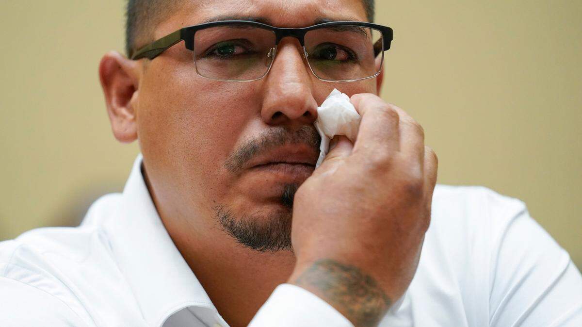 Miguel Cerrillo wipes a tear as he testifies during a House hearing on gun violence June 8, 2022. His fourth-grader was among those killed in the Uvalde, Texas massacre.